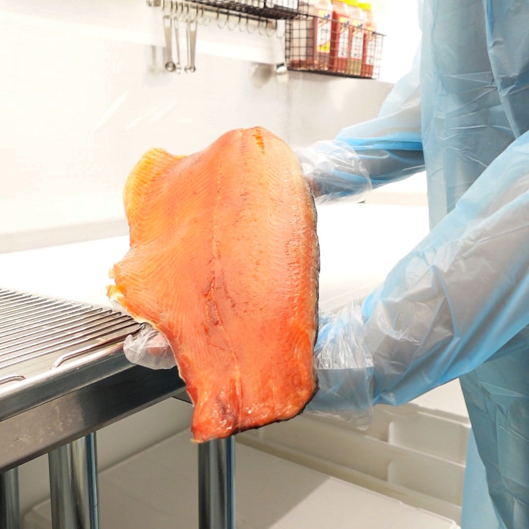 Whole side of premium smoked salmon lox with rich orange hue and silky texture